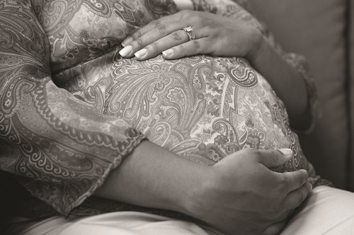 Hands resting on pregnant belly