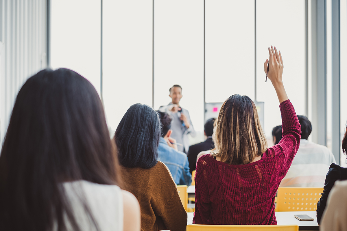 image of woman raising hand in classroom